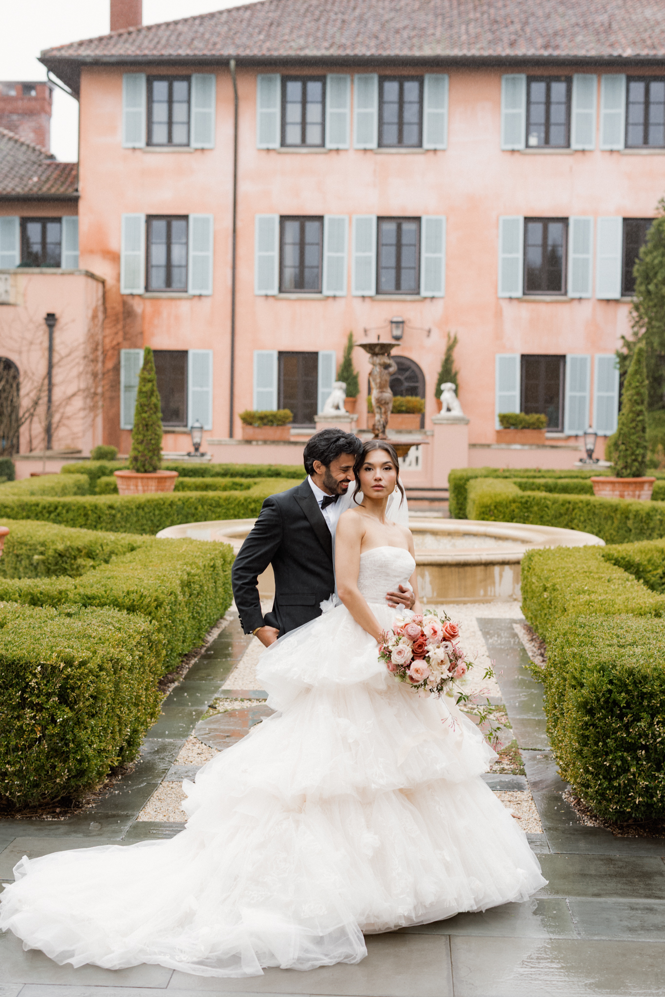 bride and groom portrait at destination wedding at glenmere mansion in the courtyard